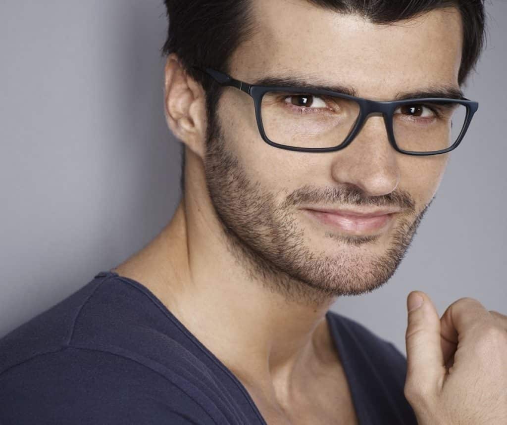 Closeup portrait of handsome young man, looking at camera.